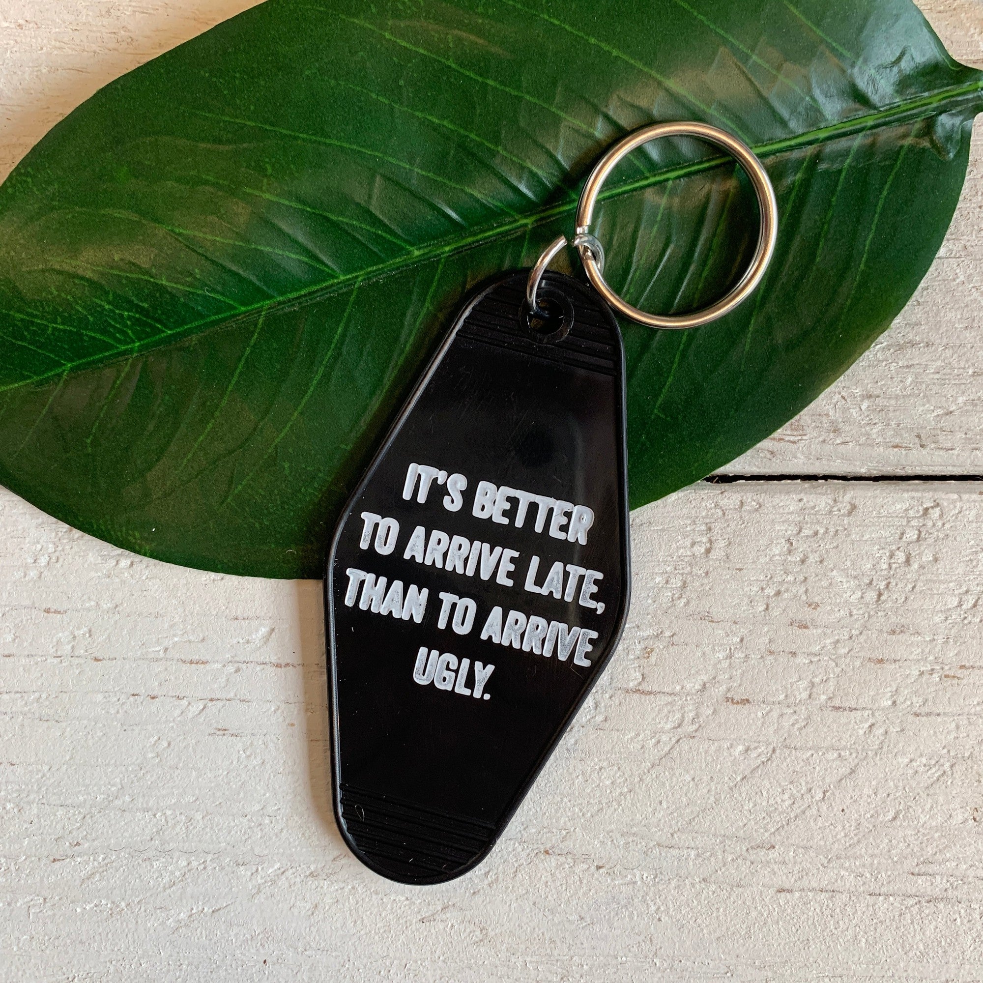It's Better To Arrive Late, Than To Arrive Ugly Keychain in Black and White by The Bullish Store