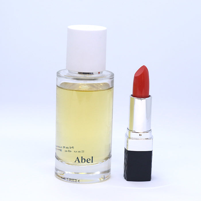 Abel Eau De Parfum in Cobalt Amber; Bellapierre Lipstick in Mandarina