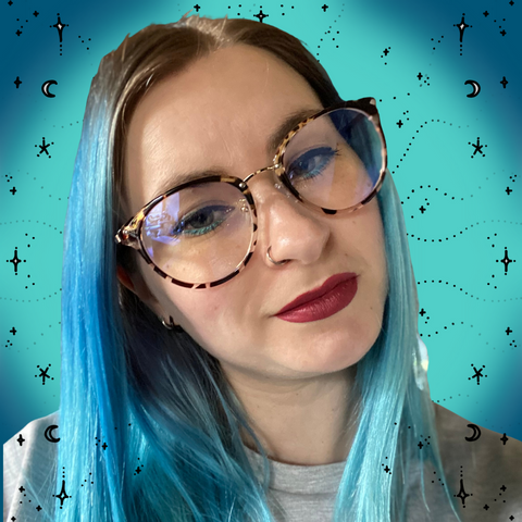 woman with blue hair, red lipstick and glasses with a teal blue with black stars background