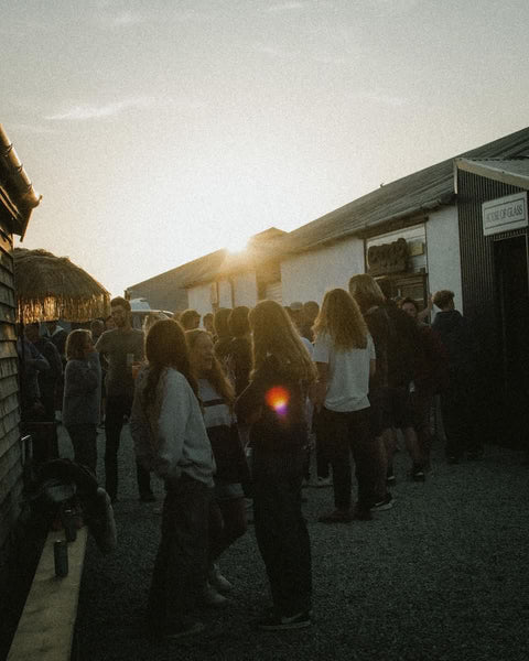 A group of surfers gathering outside House of Glass Polzeath