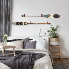 decorative canoe paddles above bed