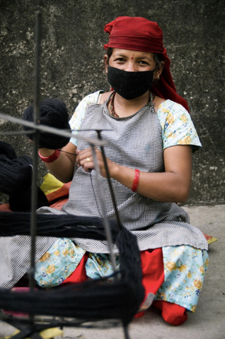 Fair Trade Artisan in Nepal Hand Winding Yarn 