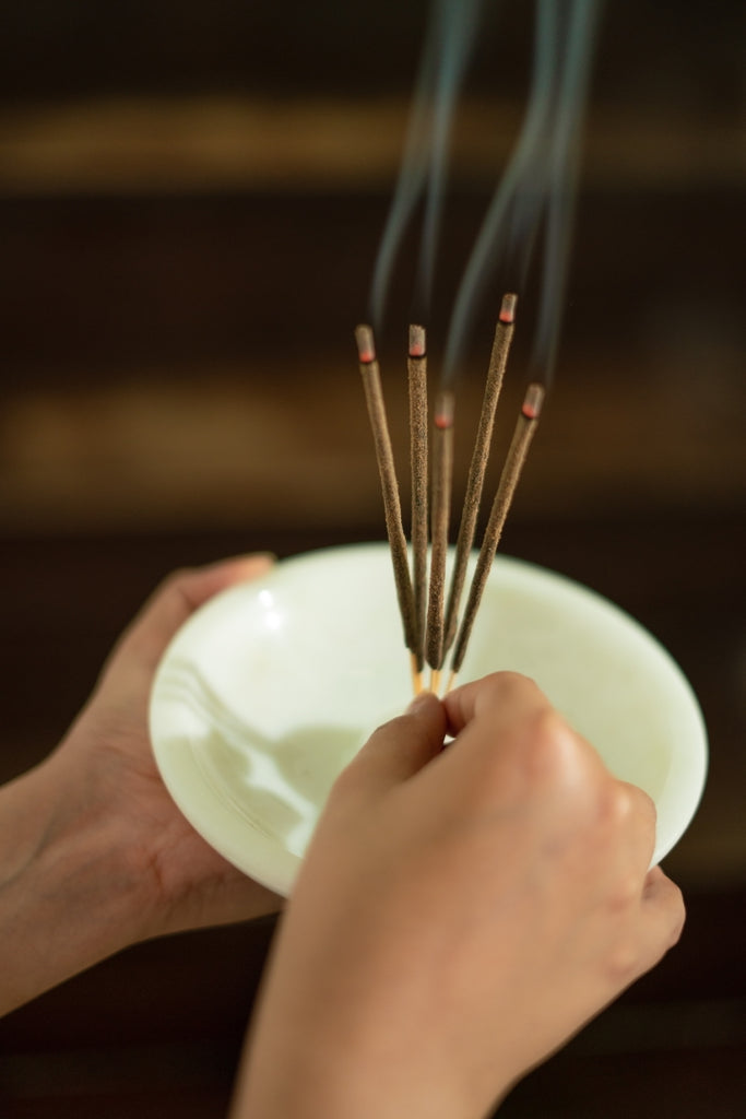 image of incense sticks on a stand