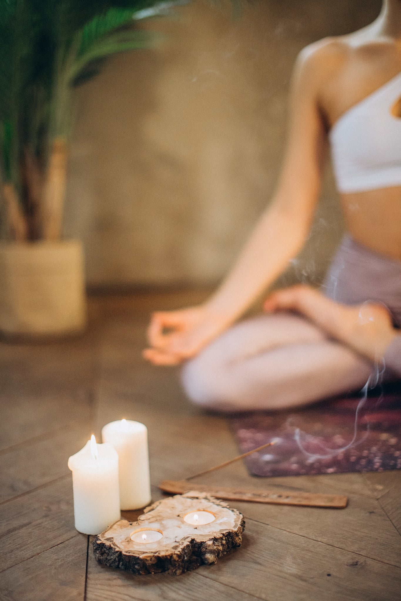 woman mediating while incense burning