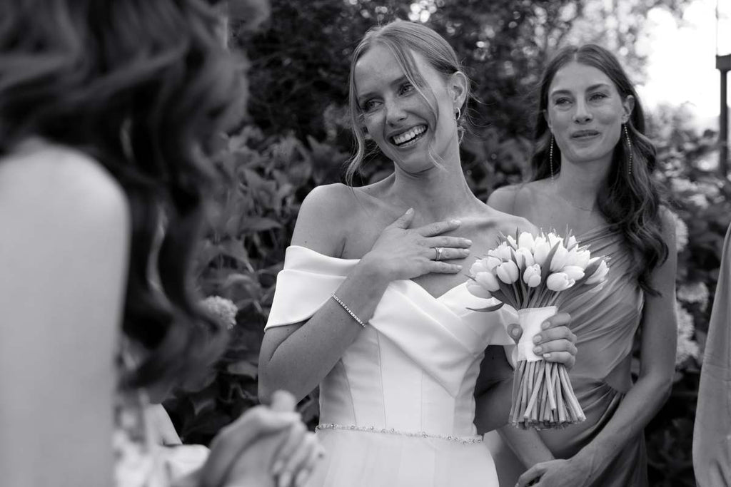 Bride feeling grateful for all the compliments on her wedding day, brides bouquet