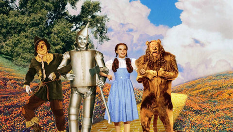 Picture of Dorthy, lion, tinman, and scarecrow from Wizard of Oz.