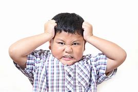 Elementary aged boy pulling out his hair.