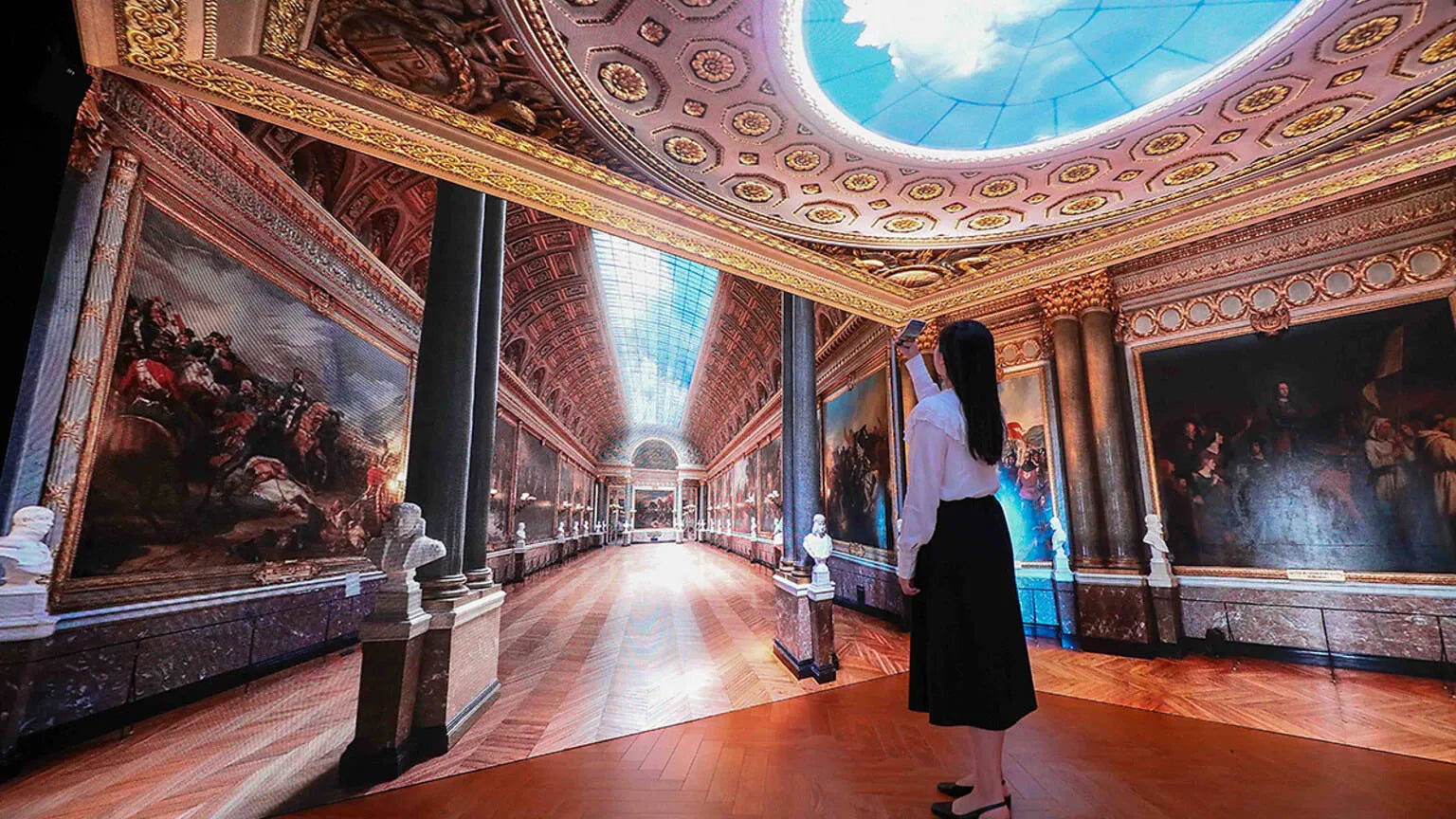 A woman takes a photo of an immersive installation at an event hosted by Le French May