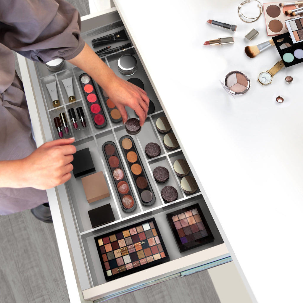 Lady organizing make up in acrylic drawer organizer