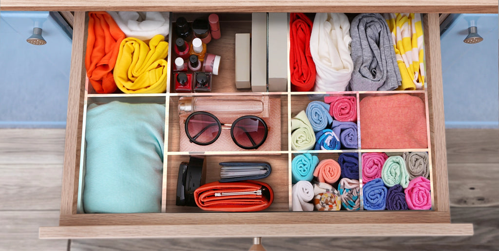 clothes and accessories organized in an acrylic drawer organizer