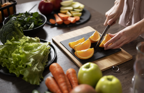 vegetables and fruits being cut on a table