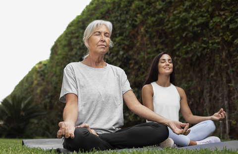 young and old women practicing meditation