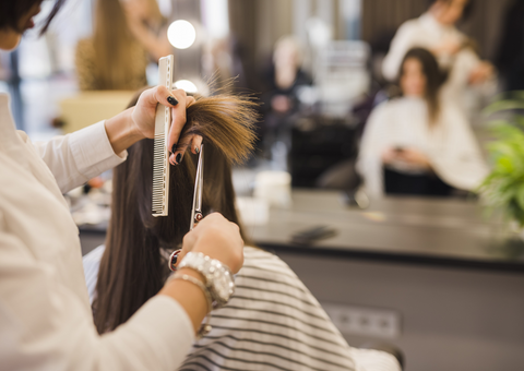 brunette woman getting hair cut