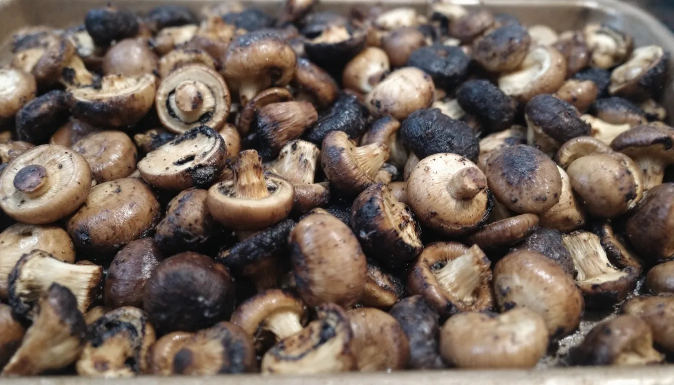 Overcrowded baking tray with overcooked mushrooms