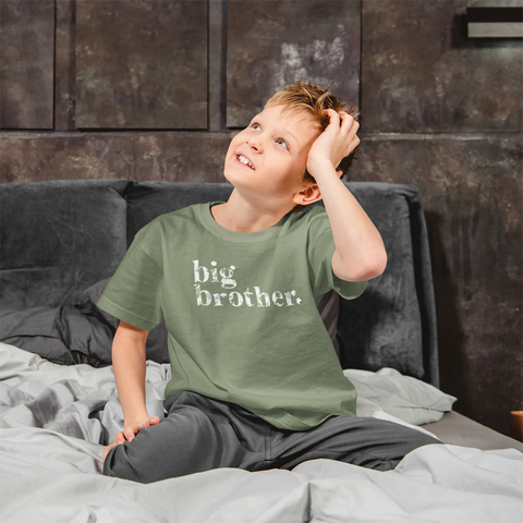 Boy wearing green floral Big Brother t-shirt.