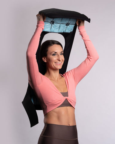 A model is pictured putting on the cool2shape cooling vest for cold exposure