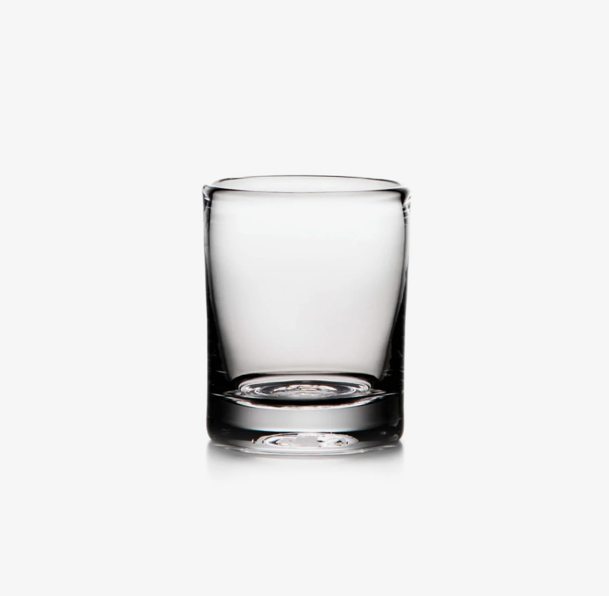 A clear, empty shot glass against a white background.