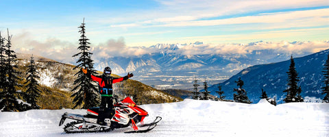 Snowmobile with mountains in background Rec Power