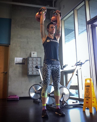 Rachel McBride lifting kettle balls in the gym