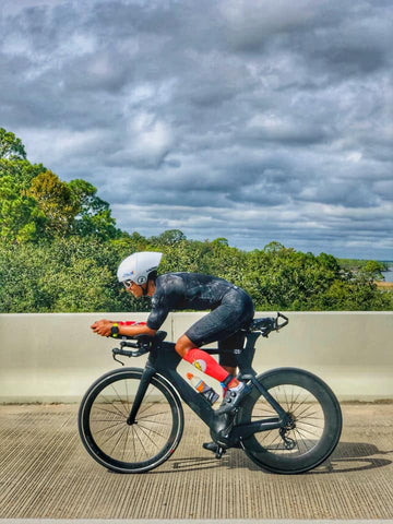 Merge Multisport team member on tri bike