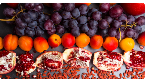 A photo of blue berries, cranberries and pomegranates.