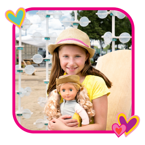 Little girl hugging girl doll on the beach