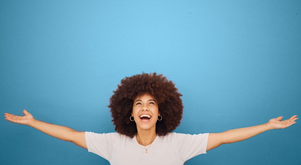 Woman stretching her arms out wide experiencing euphoria