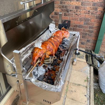 1200 mm Hooded Spartan BBQ Spit showing the pig fully cooked ready to cut and serve