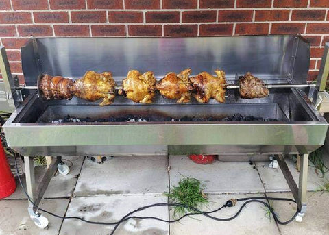 Spit Rotisserie with charcoaled chickens on and cooking