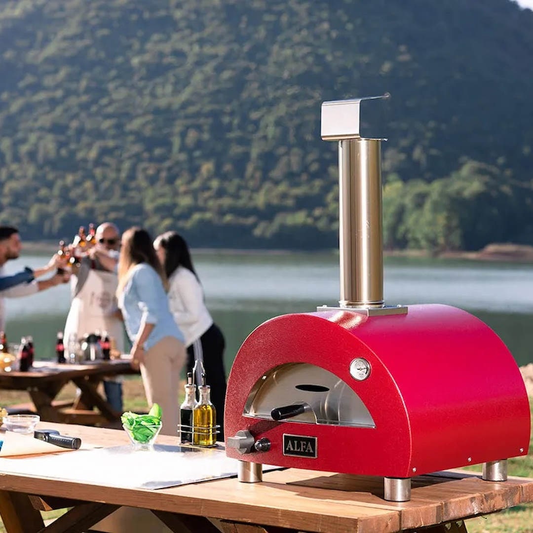 Alfa Moderno Portable Pizza Oven | on table outside with people in background