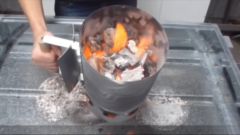 Charcoal firestarter chimney full of heated charcoal
