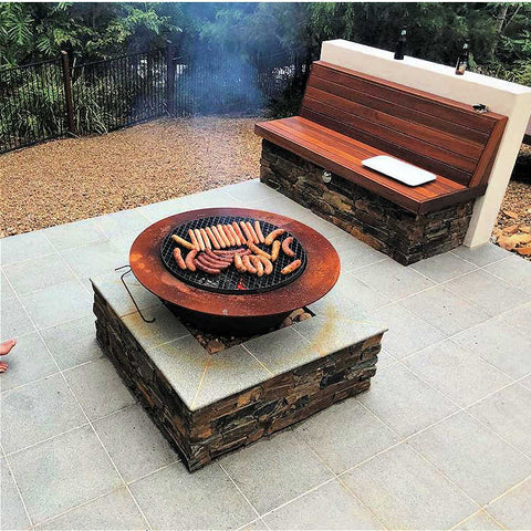 Outdoor fire pit in cast iron set in a backyard setting