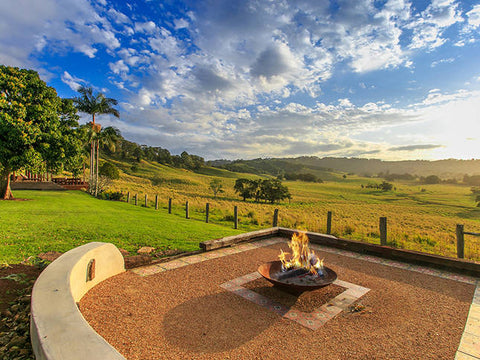 Fire pit in backyard showing a scenic focal point