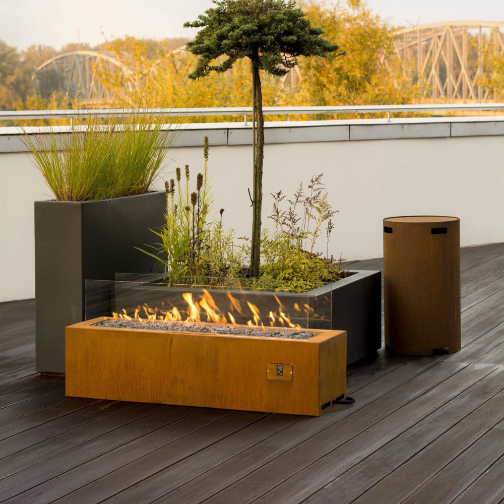 Fireplace | Planika Galio Manual | Long in corten steel on an outdoor patio