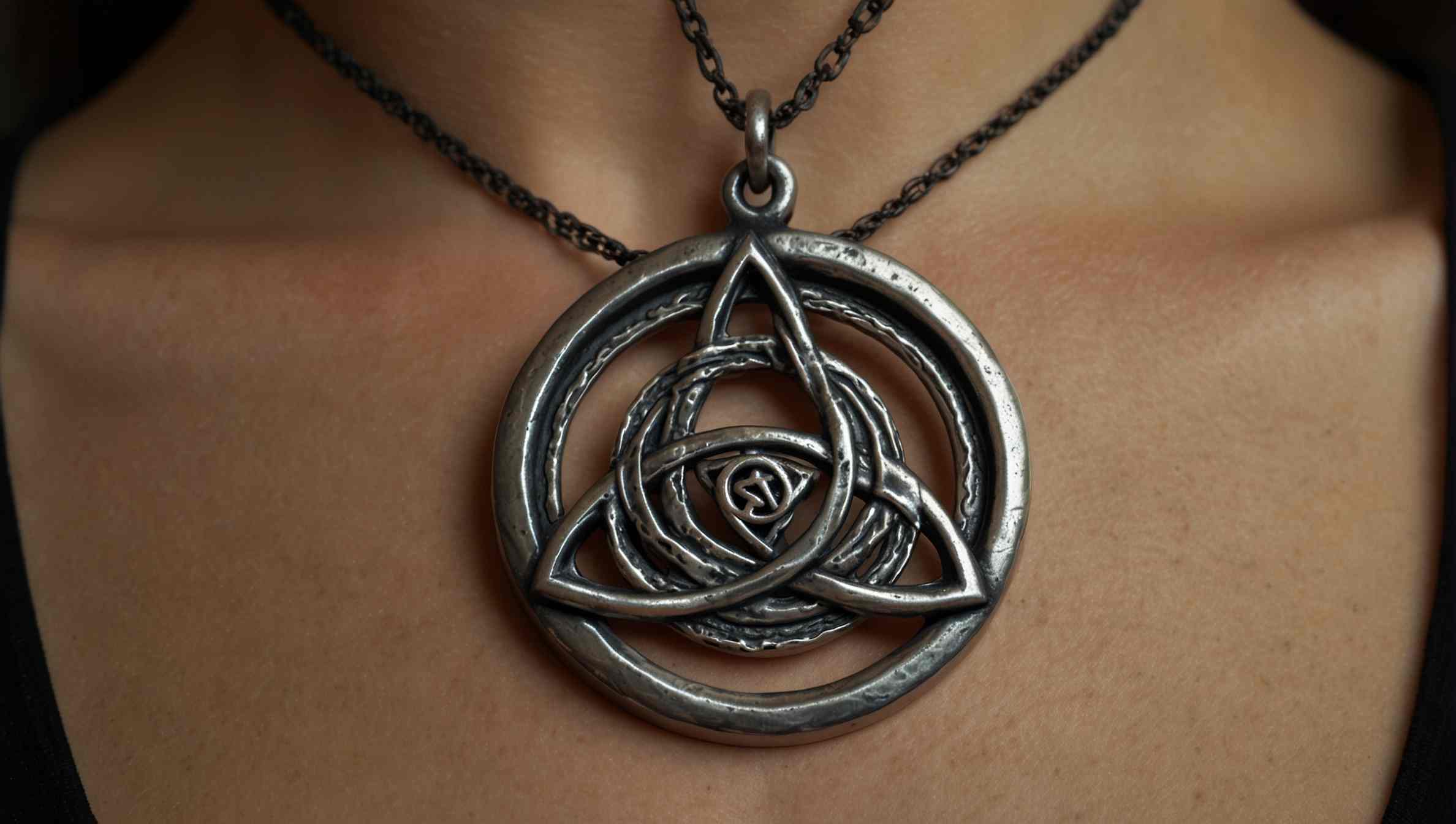 modern witch wearing a triquetra necklace