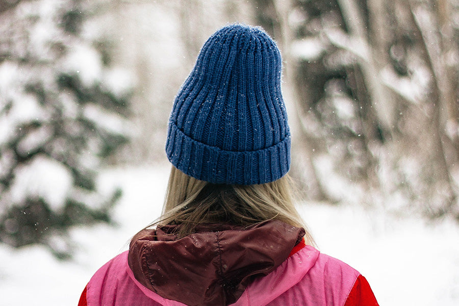 Woman wearing blue winter hat