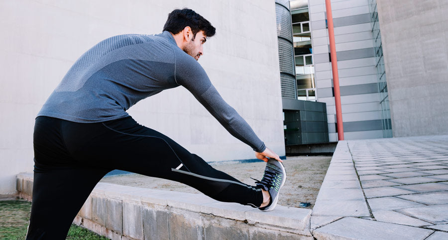 sporty man warming up street