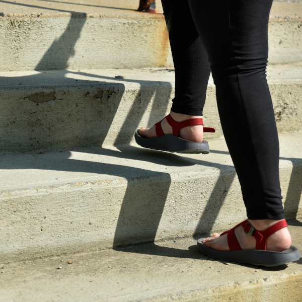 woman walking up the stairs in orthotic sandals