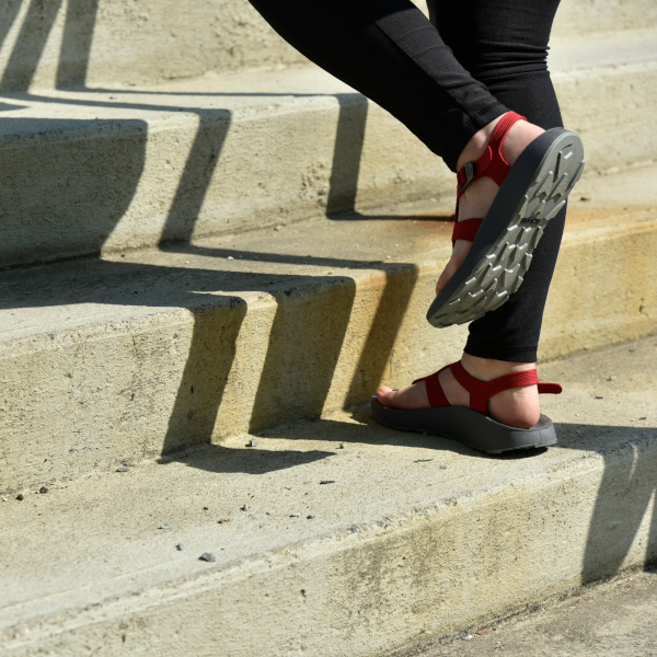 woman walking up the stairs in orthotic sandals