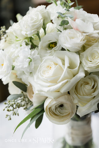 image of an uplcose shot of a white, green and neutral bridal bouquet