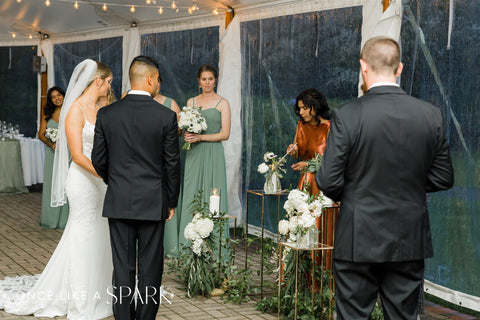 Image of couple during weddign ceremony at Stevens Estate with modern white and green florals