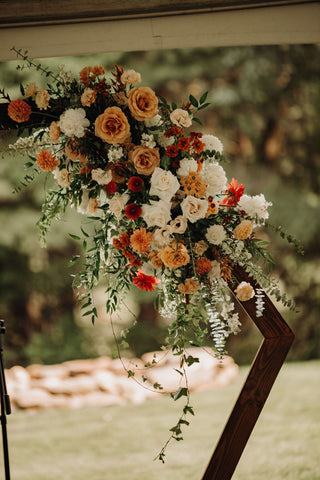 Image of hexagon arch with stunning floral installation with shades of pink.