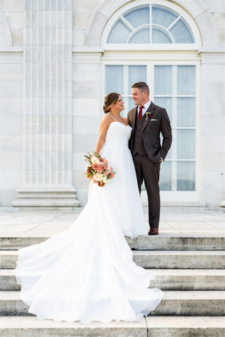 Image of bride and groom on stairs at a Newport mansion during wedding portraits