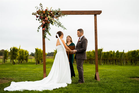 Newport Vineyards wedding. Wedding arbor with floral installation. Flowers in muted early fall color pallete.