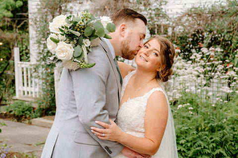 Summer Wedding at the Herb Lyceum - affectionate couple with bridal bouquet