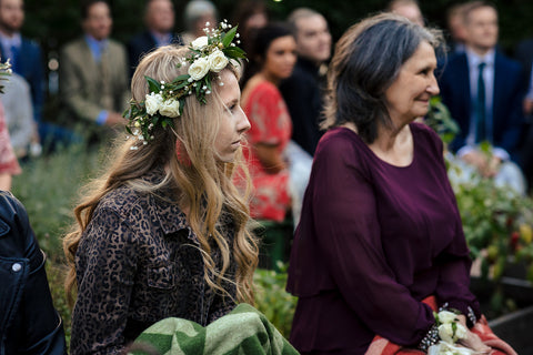 floral crown on wedding guest during ceremony