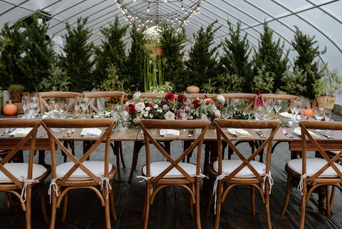 Deep red, pale pink and white florals with greenery wedding reception tablescape