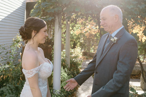 Father of the bride with his daughter on her wedding day. Highlights fathers boutonniere.