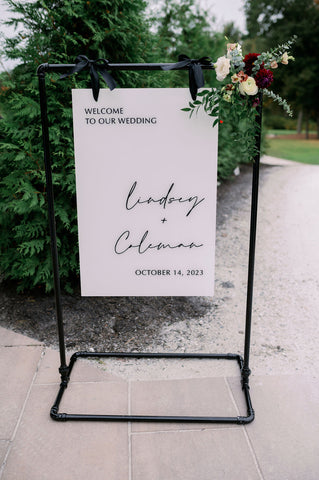 Image of wedding welcome sign adorned with fall florals.