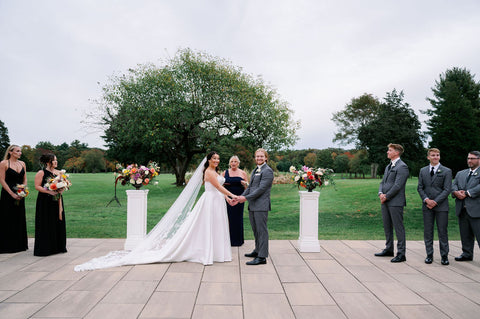 Image of bride and groom during their outdoor wedding ceremony at the Cape Club of Sharon.